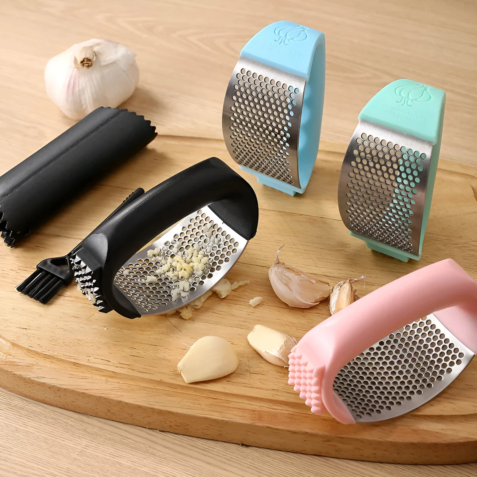Stainless steel garlic press with coloured handle in green, pink, black, or blue option