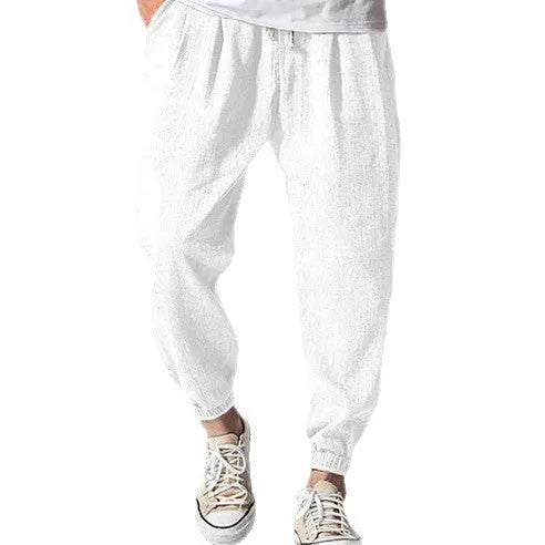 Man wearing light-coloured cotton banded ankle pants with a loose, casual fit.