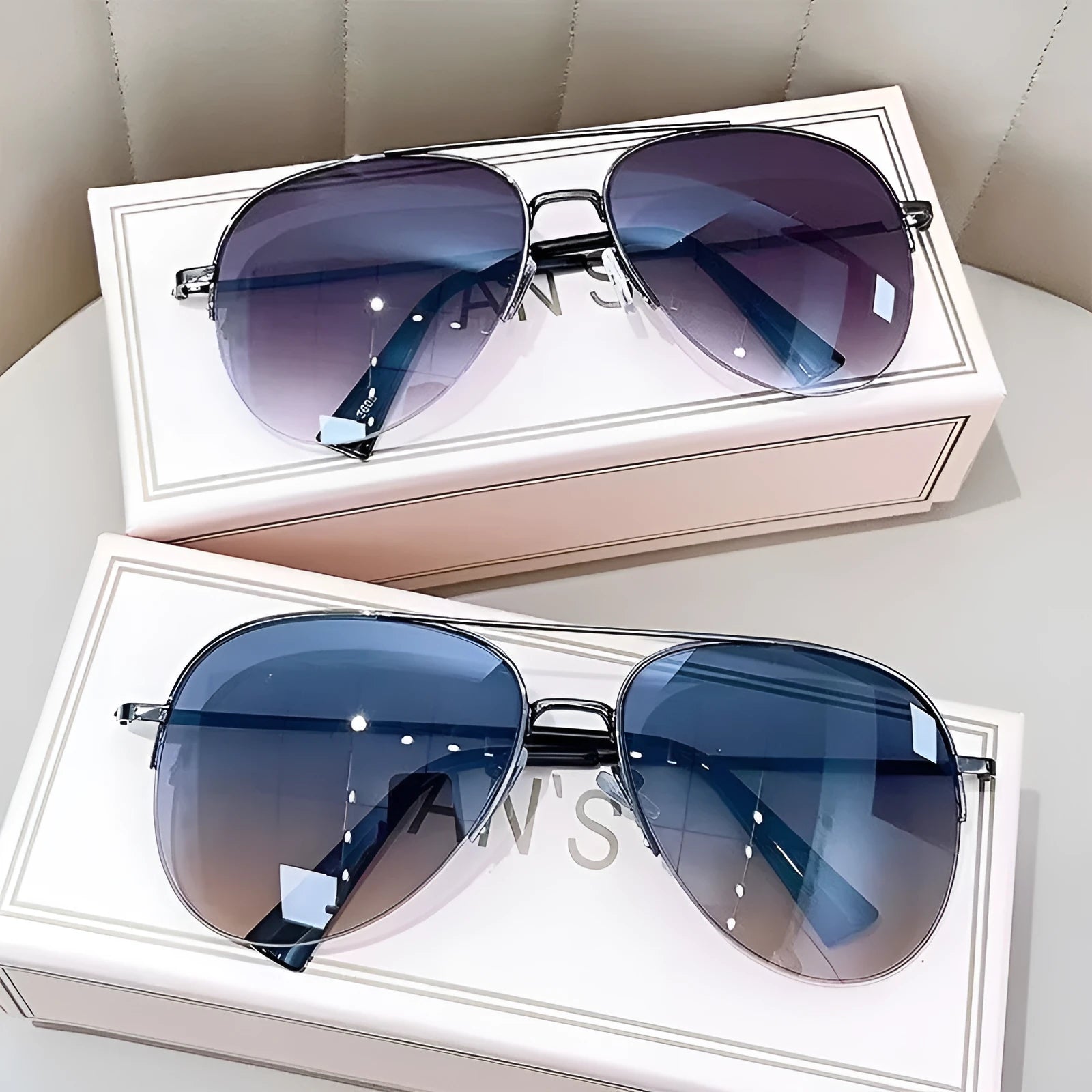 Aviator-style sunglasses with a metal frame and tinted resin lens, shown in a gold frame variant.