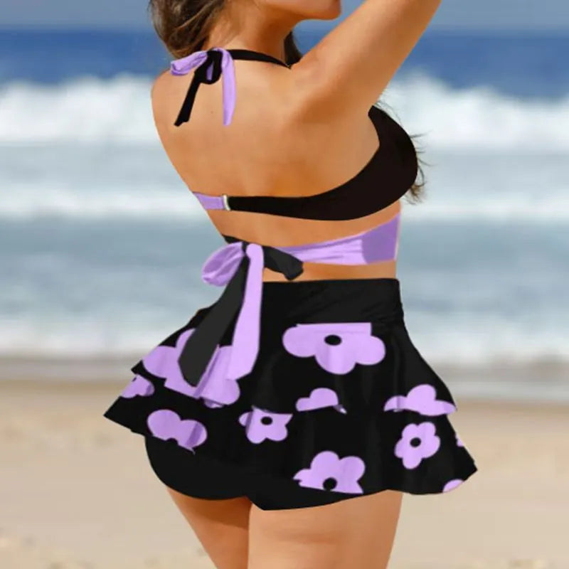 Purple and black women's bikini set with lace-up front and high-waisted split skirt.