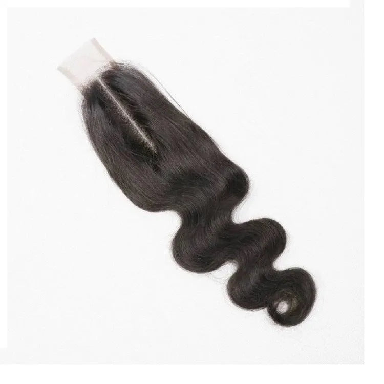 A straight, natural-coloured human hair wig displayed on a stand, showing its length and hand-woven cap construction.