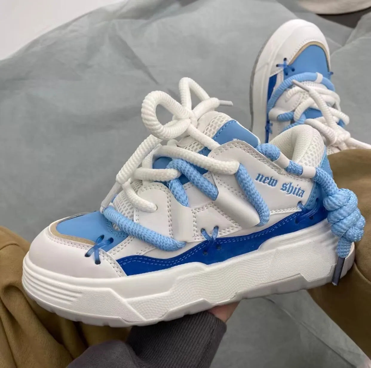 Women's grey retro chunky platform sneakers with thick rubber sole and lace-up design.