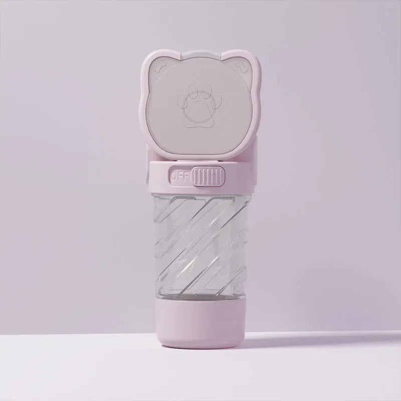 Green 3-in-1 portable pet water bottle with integrated food container and waste bag dispenser on a strap.