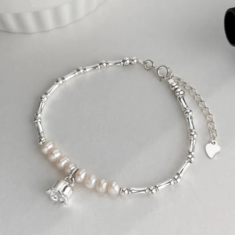 Silver pearl Lily of the Valley pendant bracelet on display