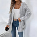 Long sleeve loose fit cardigan in grey with a pocket, shown on a hanger.