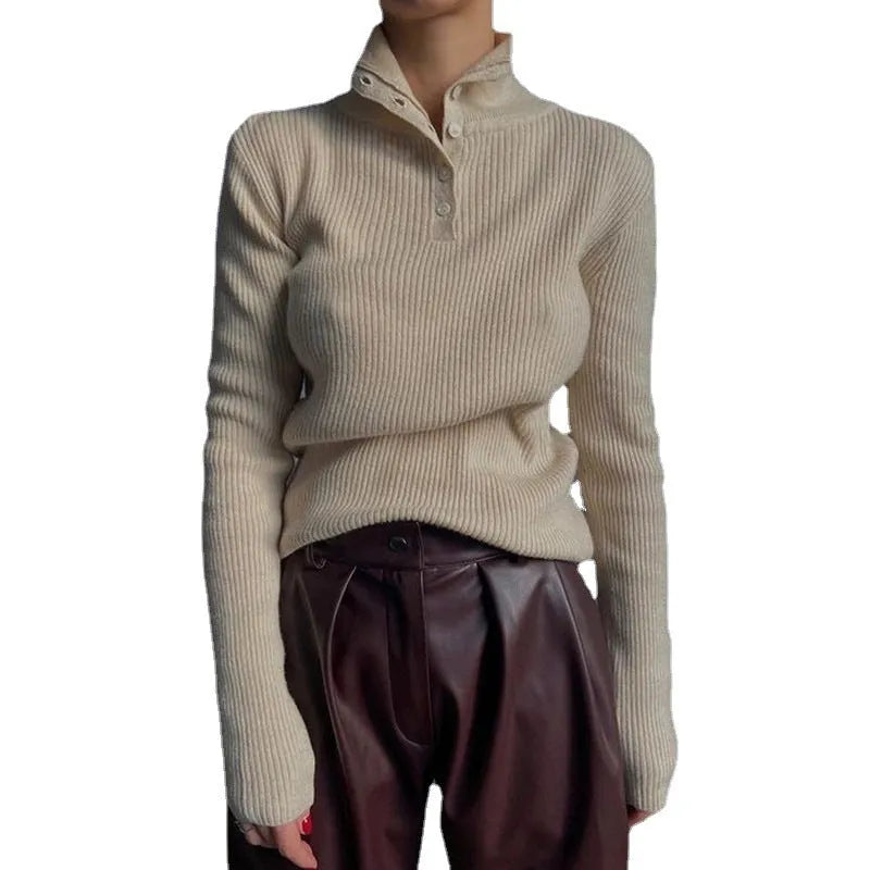 Slim fit silver grey half turtleneck sweater with a breasted button placket on a mannequin.