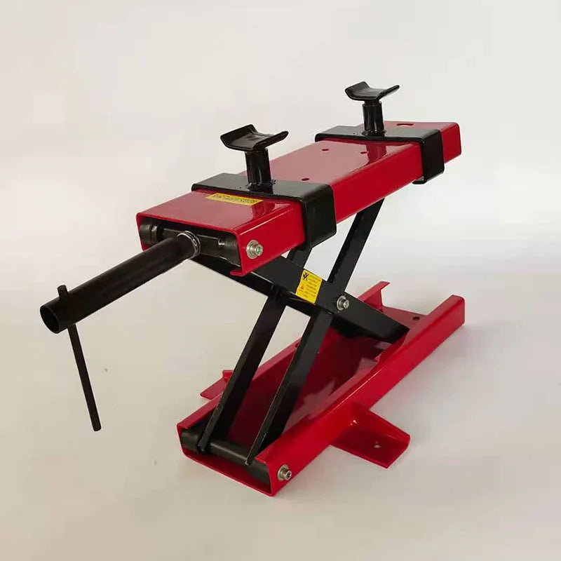 Red motorcycle support lift table raising a bike 16 inches above the ground for repair work