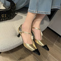 Women's gold stiletto shoe with floral detail, pointed toe, and a shallow cut opening.