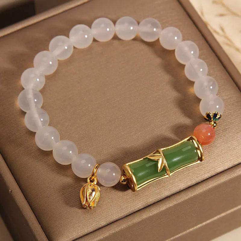 Close-up of a white agate and jade bamboo joint bracelet for women, traditional Chinese style.