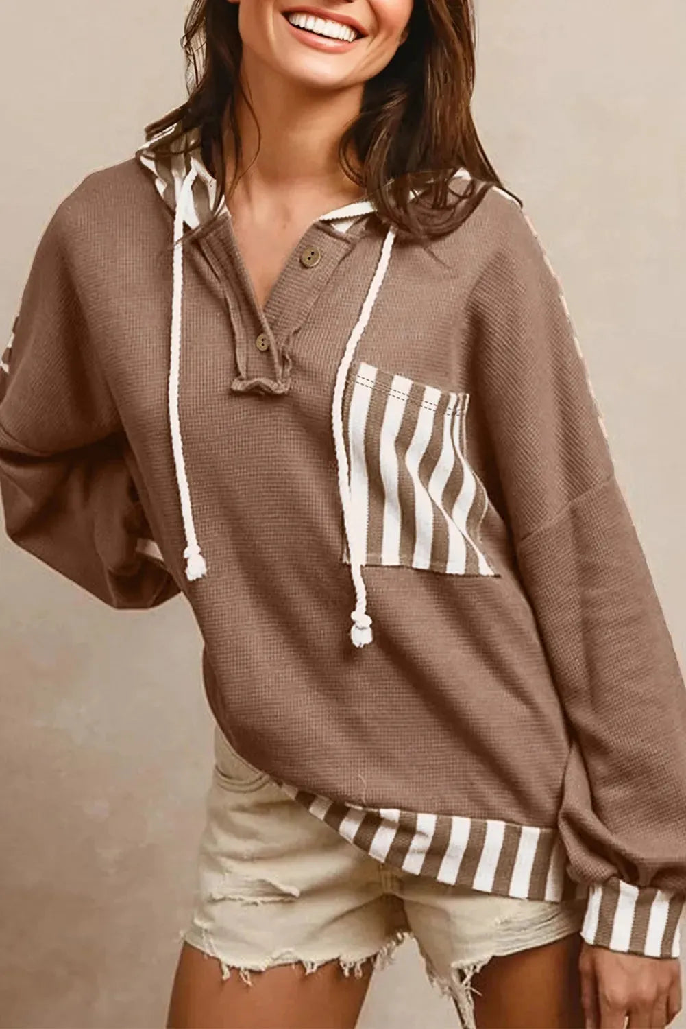 Straw yellow hoodie with waffle texture stripes and patchwork design featuring button neck and drawstring hood