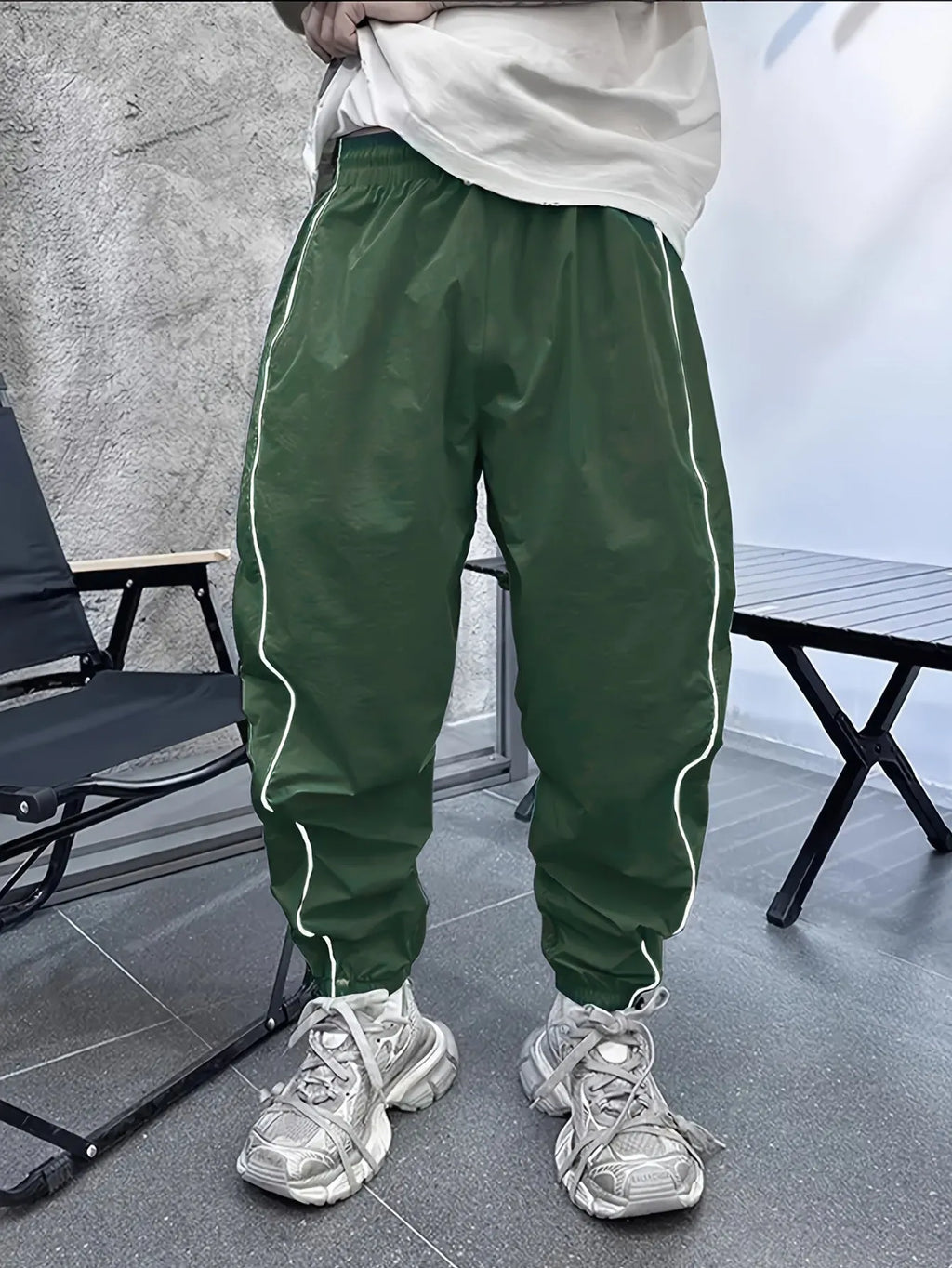 Men's loose fit cropped sports trousers in bamboo fibre fabric shown in army green colour.