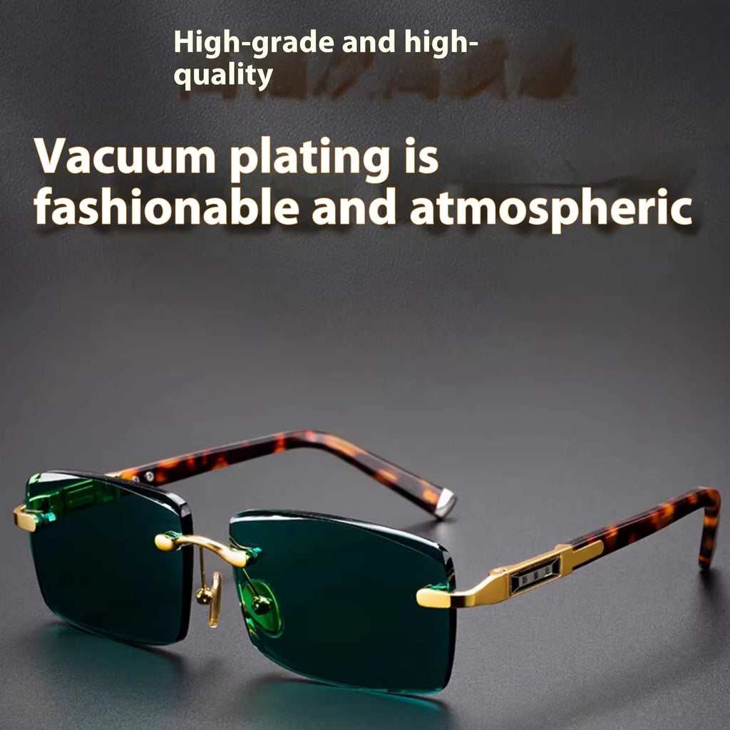 Dark green frameless crystal sunglasses with a matching case and cleaning cloth on a table.