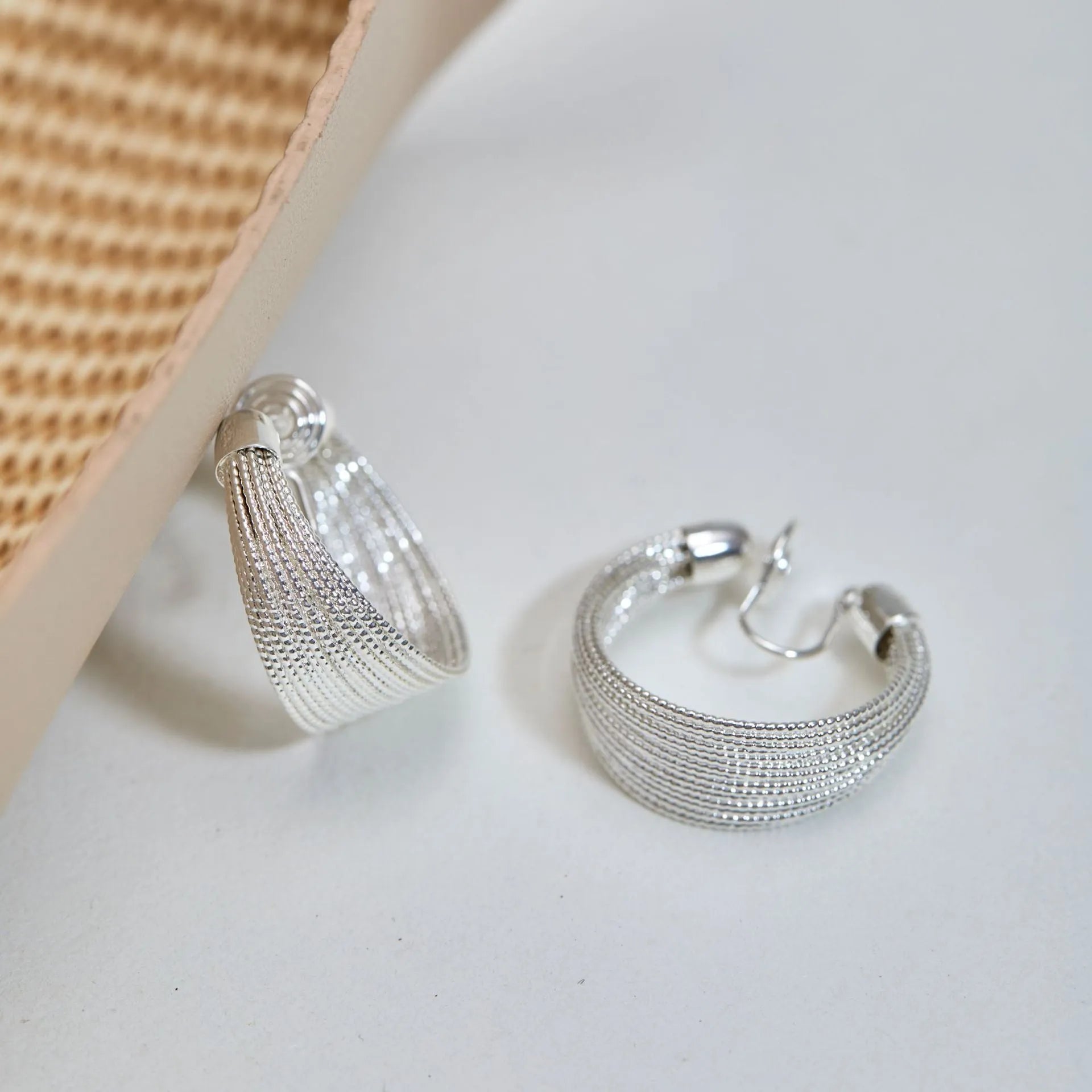 Multi-layer geometric copper earrings with electroplated gold or silver finishes, available as stud or clip styles
