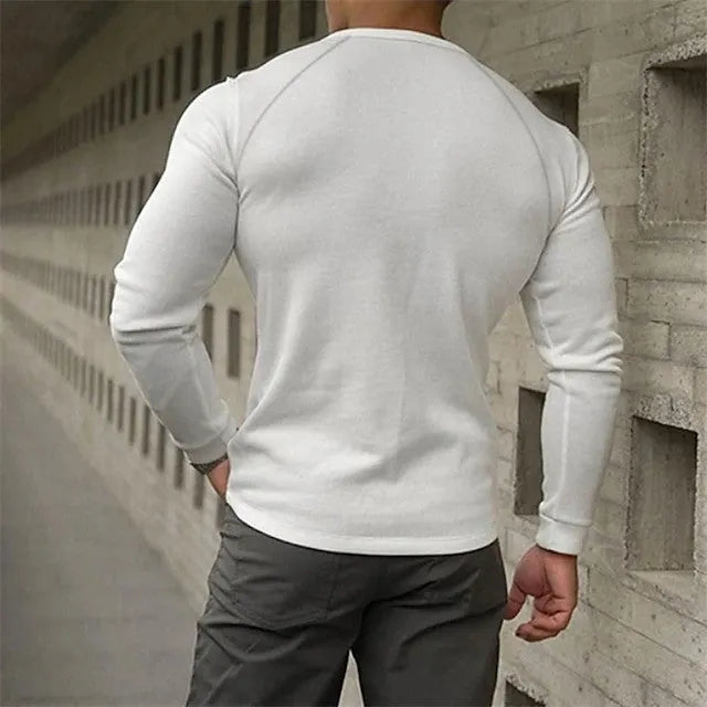 Men's white long-sleeved t-shirt with a Henry collar on a hanger.