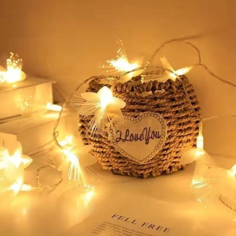 LED optical fiber flower light string with 20 warm white beads and plastic shell, battery powered, available in 1.5m to 100m lengths.
