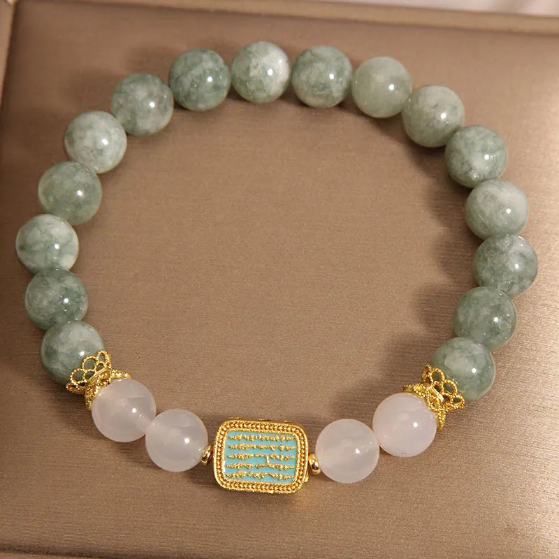 Women's oil green emerald crystal bracelet showing five scripture elements on wrist