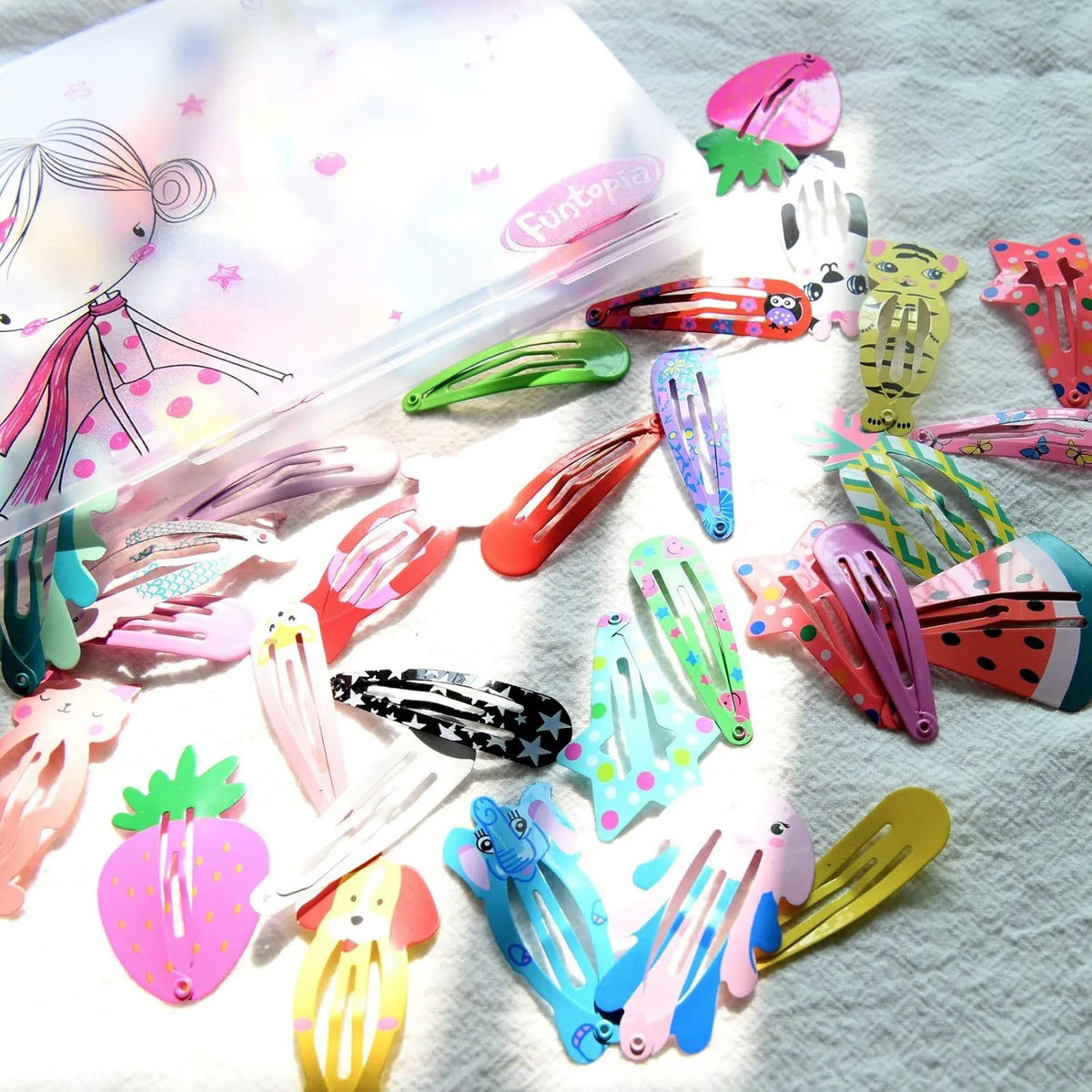 Assortment of 100 metal snap hair clips showing animal, fruit, crown, star, and flower designs.