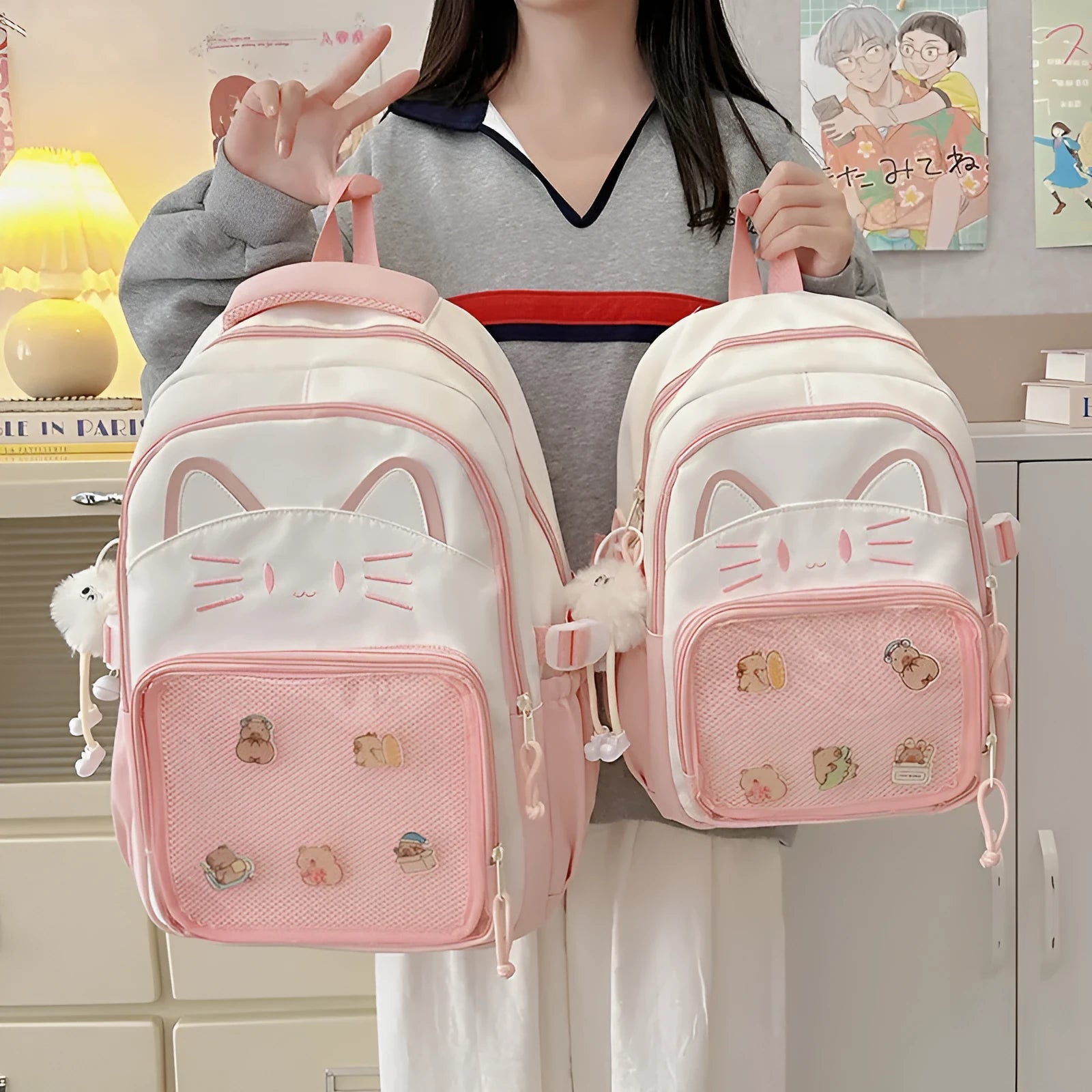 Cartoon style large capacity nylon backpack in pink with badge pendant, showing curved shoulder straps