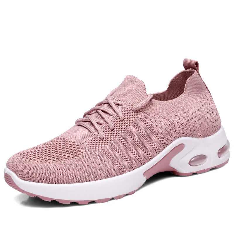 Women's black mesh casual sneakers with lace-up front and round toe on a grey background.