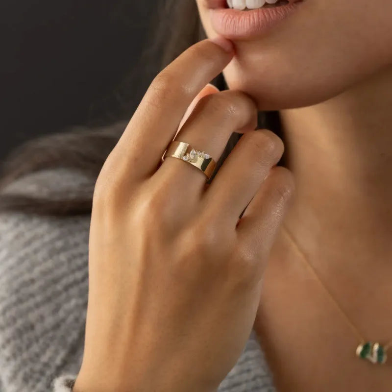 Gold electroplated copper women's fashion ring with shining zircon stones.