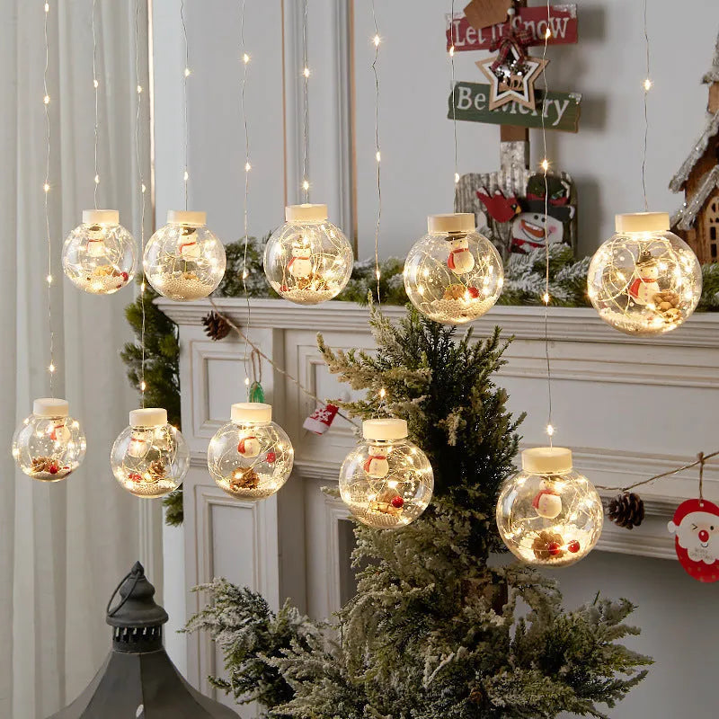 Set of 10 LED Christmas curtain lights with fairy and snowman wishing ball designs on a string.
