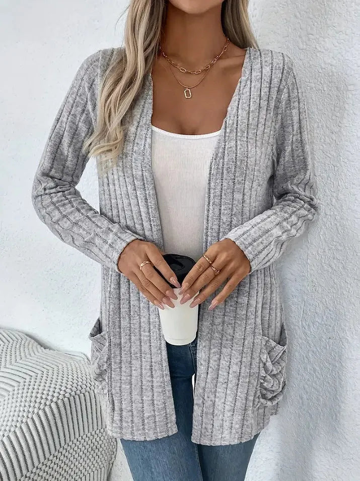 Long sleeve loose fit cardigan in grey with a pocket, shown on a hanger.