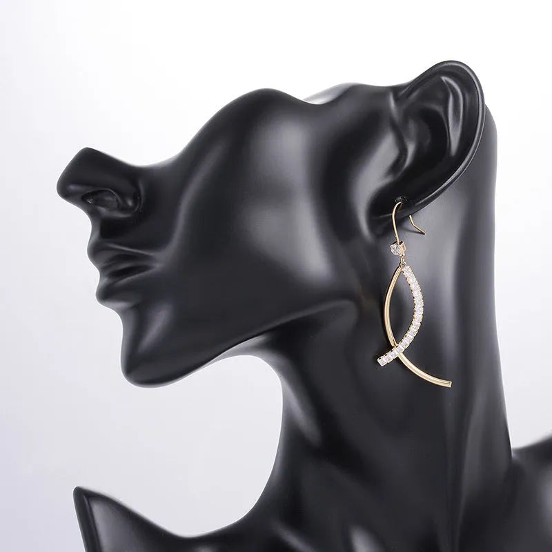 Pair of gold irregular geometric copper earrings on display