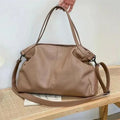 Large horizontal square soft PU messenger bag with zip and adjustable strap in four colour options.