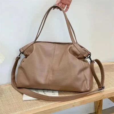 Large horizontal square soft PU messenger bag with zip and adjustable strap in four colour options.
