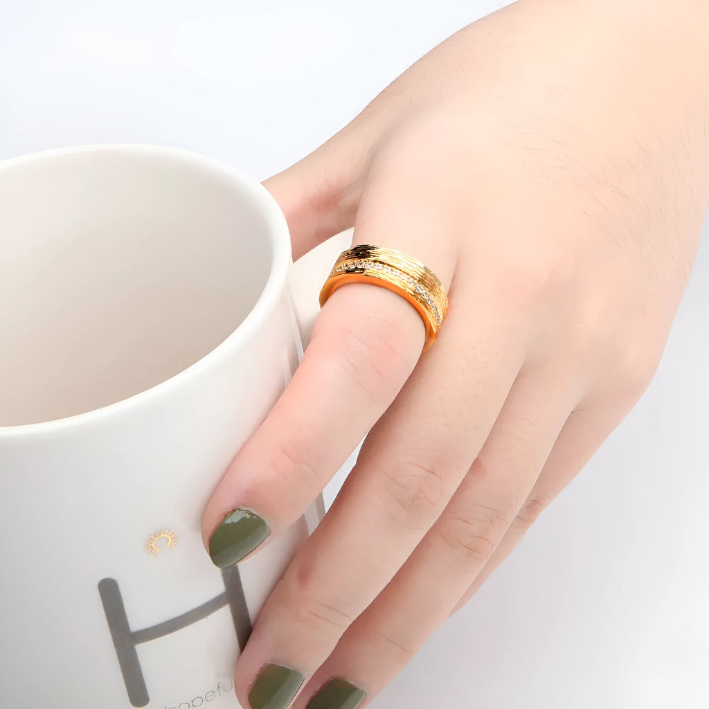 Gold geometric zircon ring on finger showing angular design and electroplated finish
