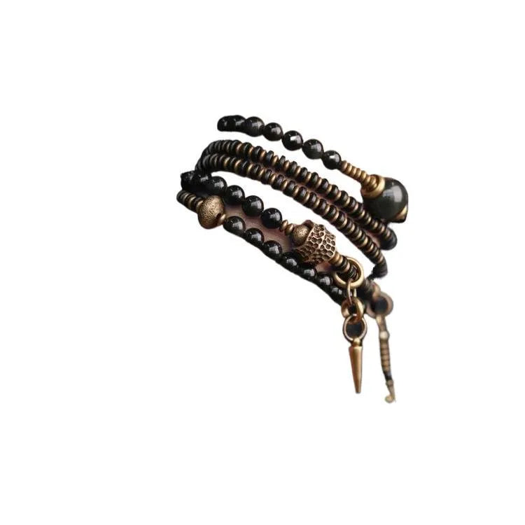Black multi-layered beaded bracelet with geometric styling on wrist