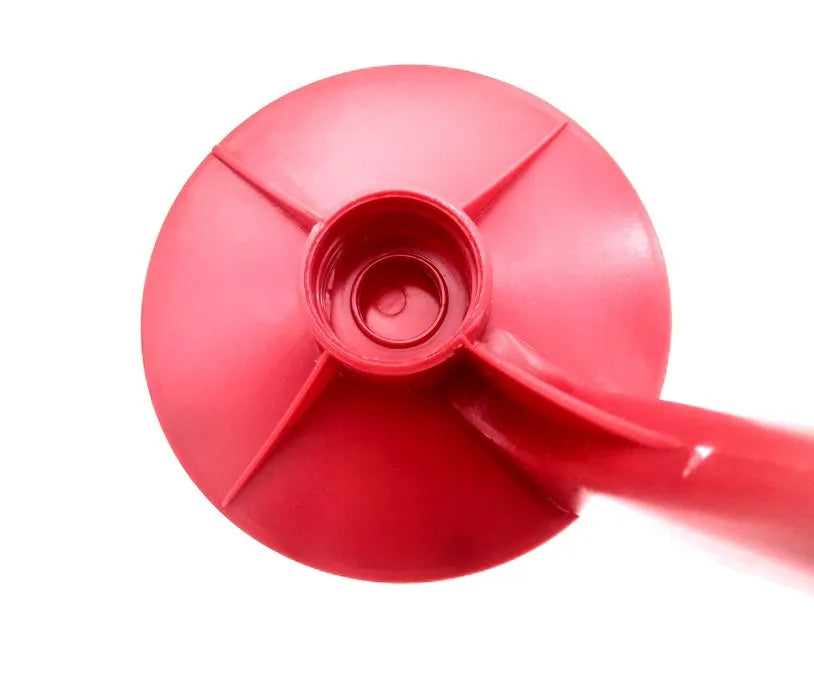 Red plastic Magic Tap soda drink dispenser for 2-litre bottles on a kitchen counter.