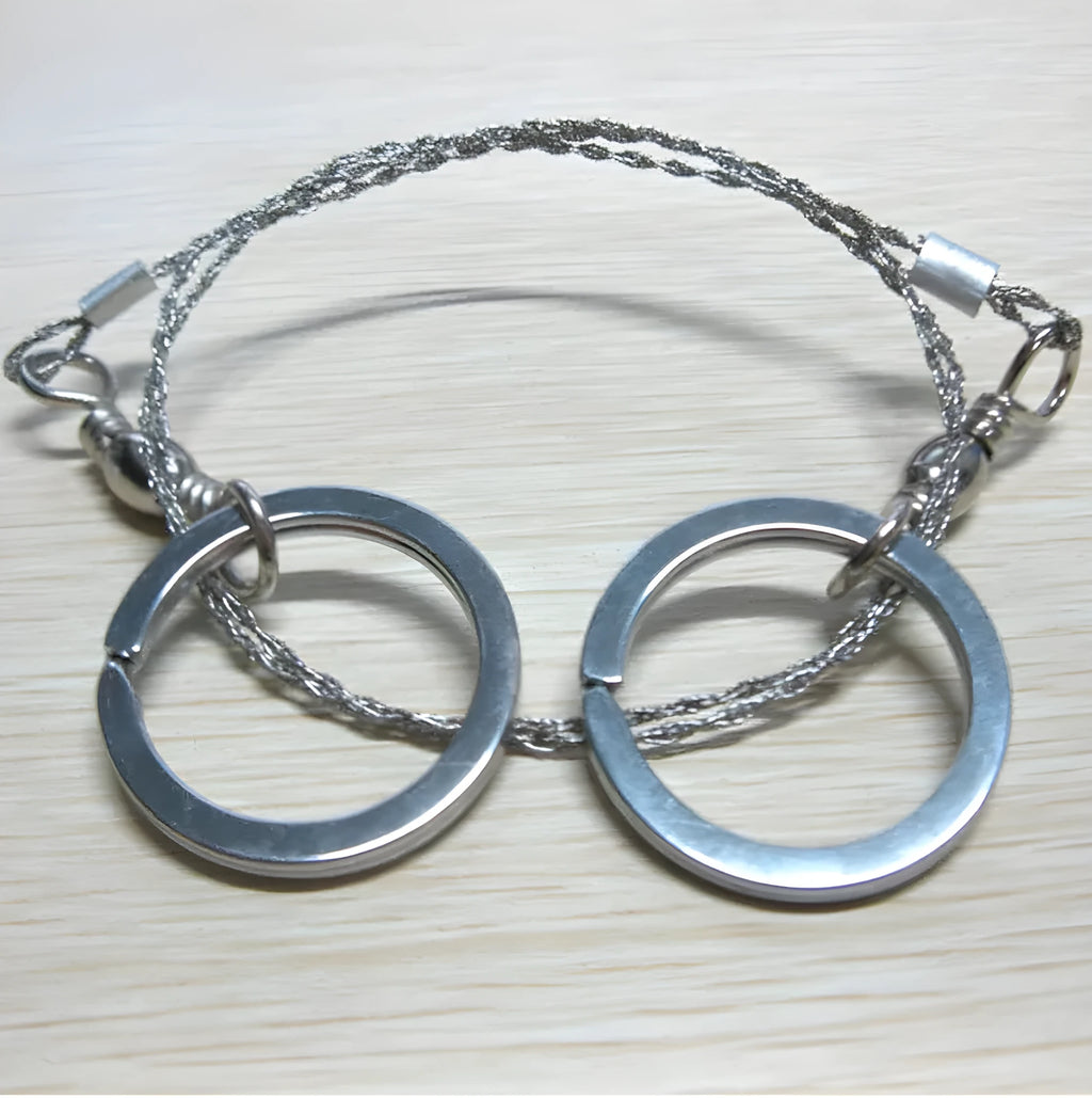 Survival wire saw with stainless steel blade and thumb rings for outdoor cutting tasks