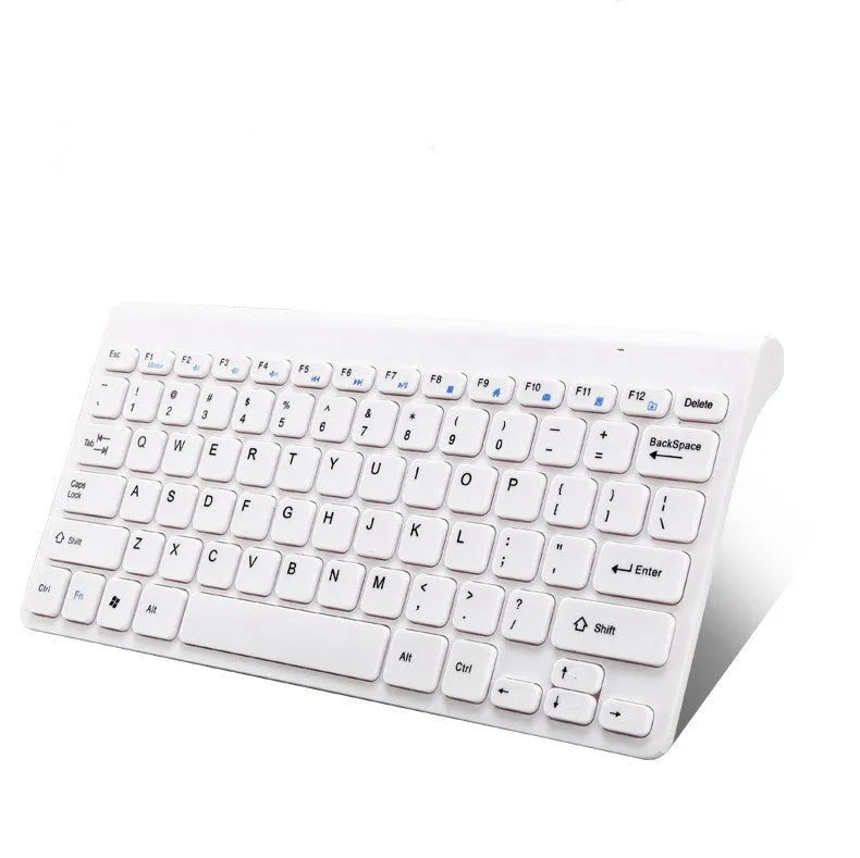 Black and white 2.4 GHz wireless keyboard and mouse set with USB receiver on a desk.