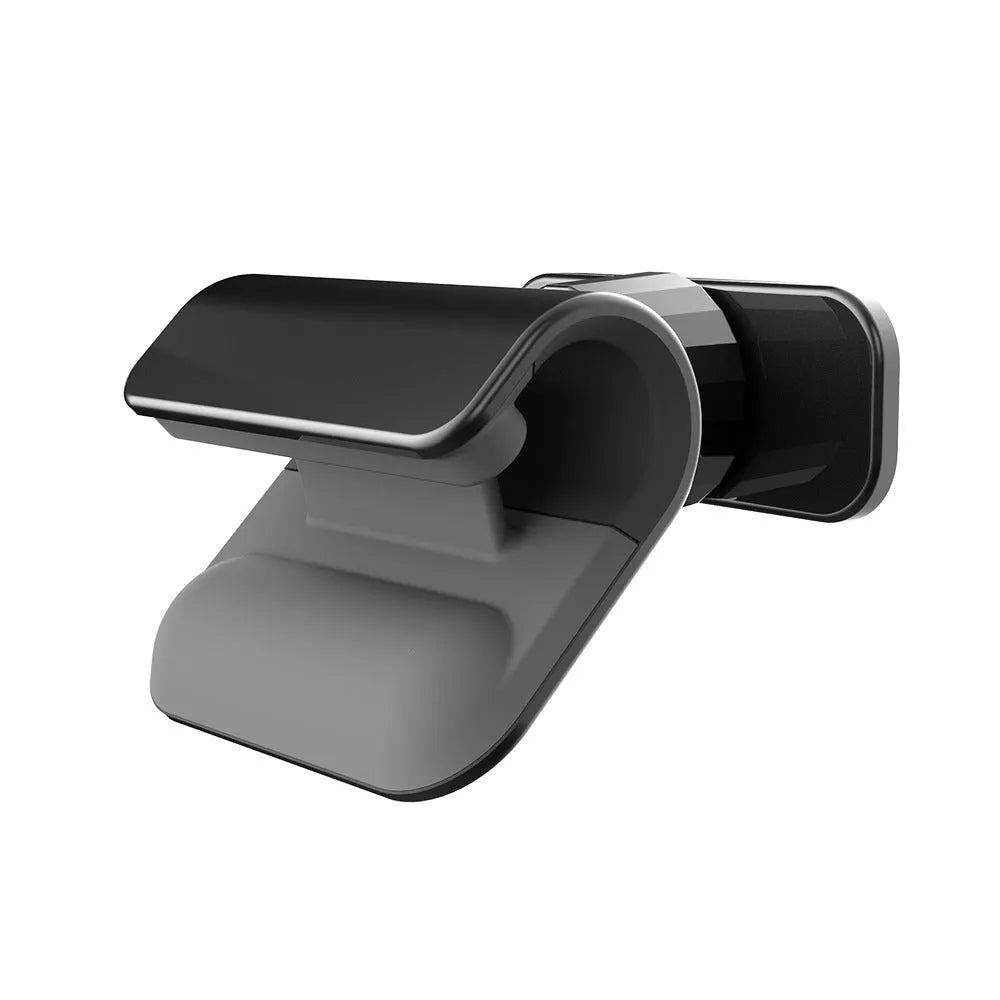 Black universal gravity car phone holder mounted on a dashboard, showing 360-degree rotation.