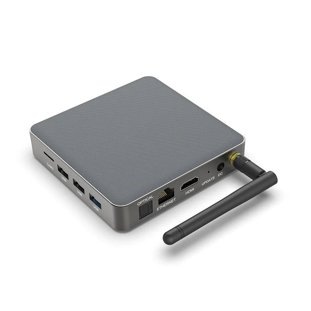 Black Android TV set-top box with remote control on a white background