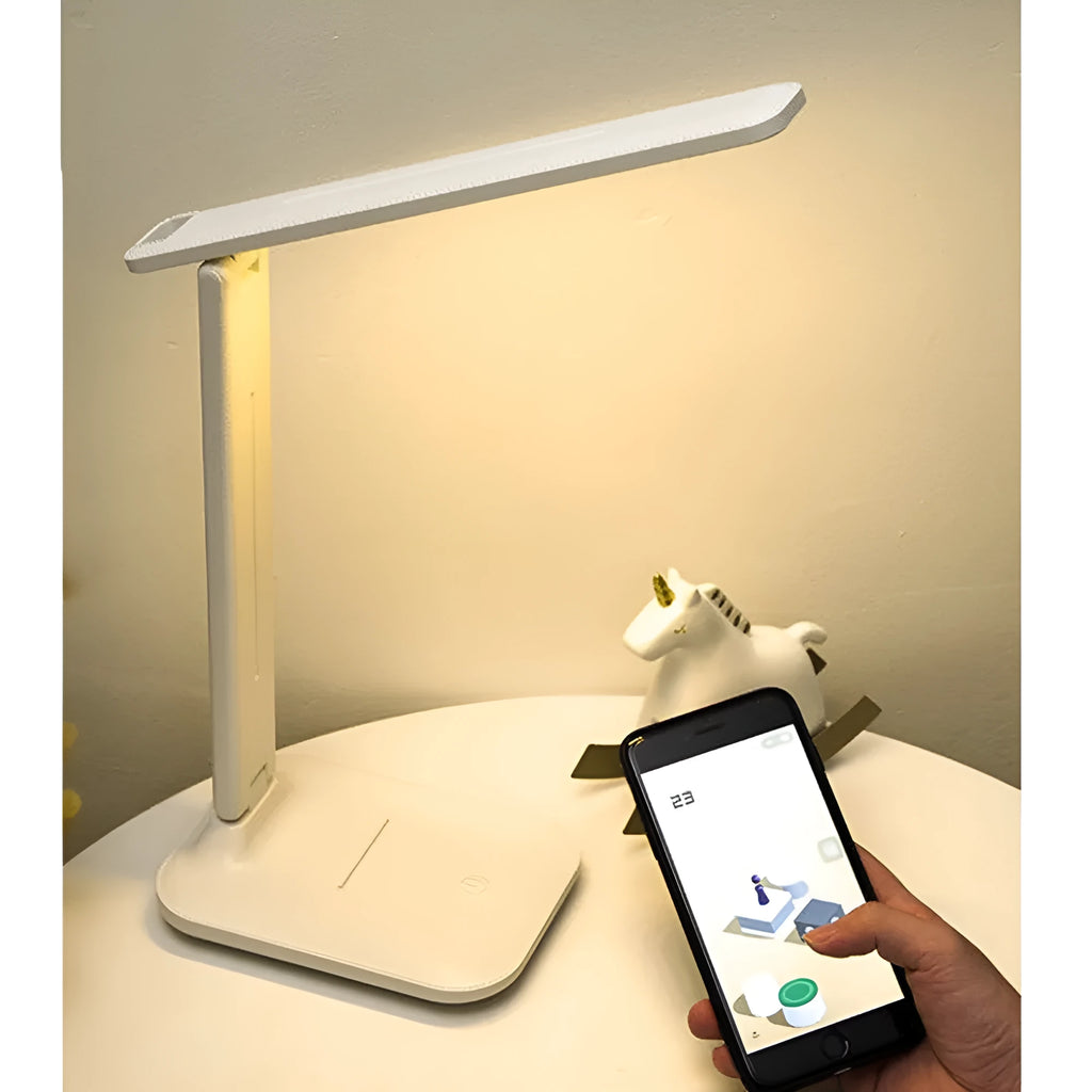 White plastic USB rechargeable bedside lamp with touch dimming control on a wooden surface.