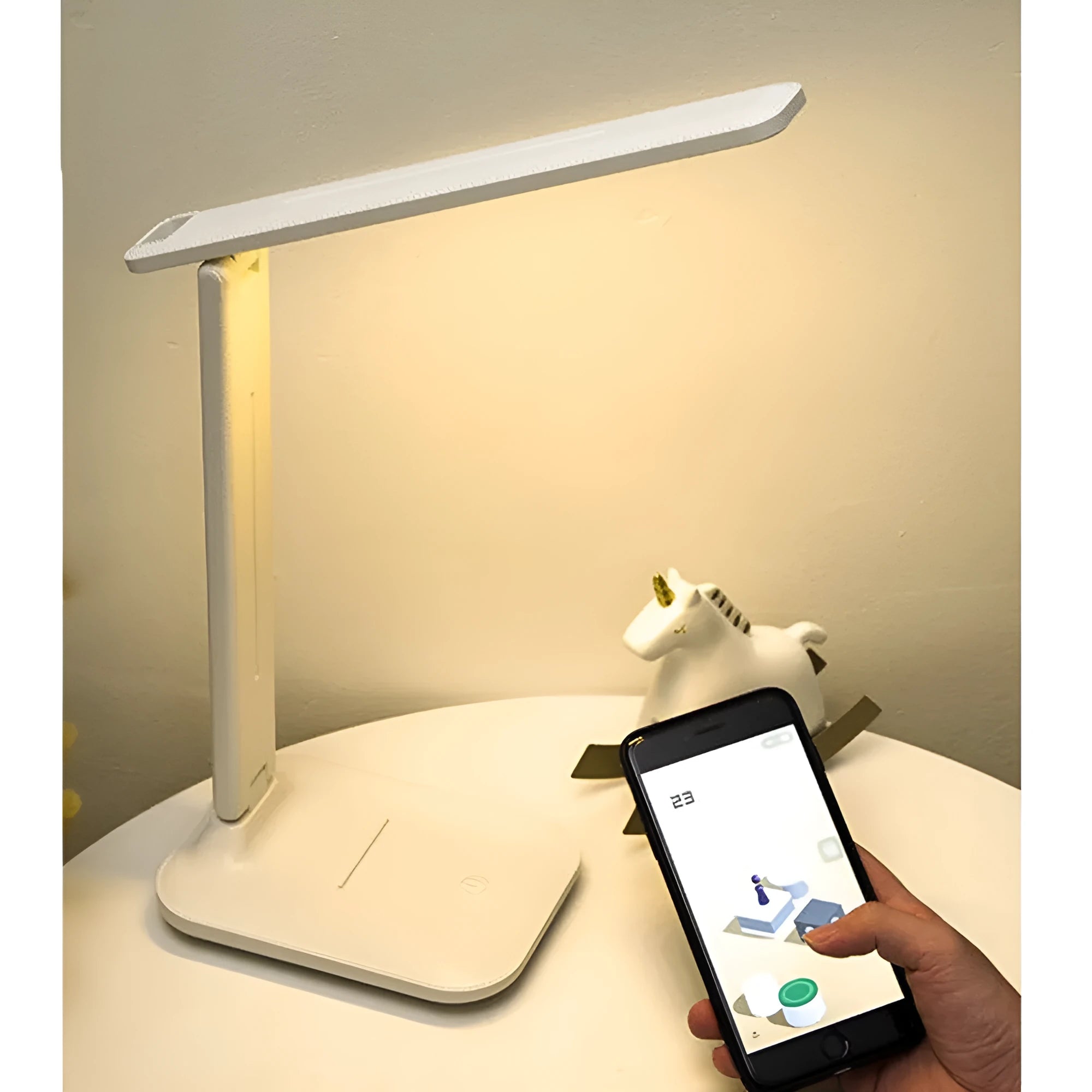 White plastic USB rechargeable bedside lamp with touch dimming control on a wooden surface.