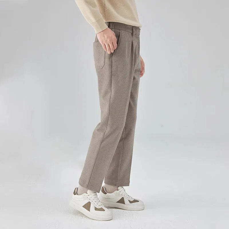 Men's beige corduroy straight leg loose fit trousers with a mid-rise elastic waistband.