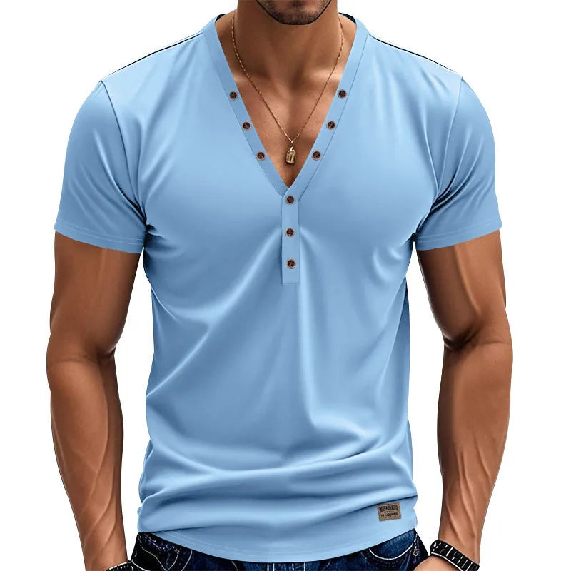 Man wearing a loose fit grey v-neck pullover top with button detail on the neckline