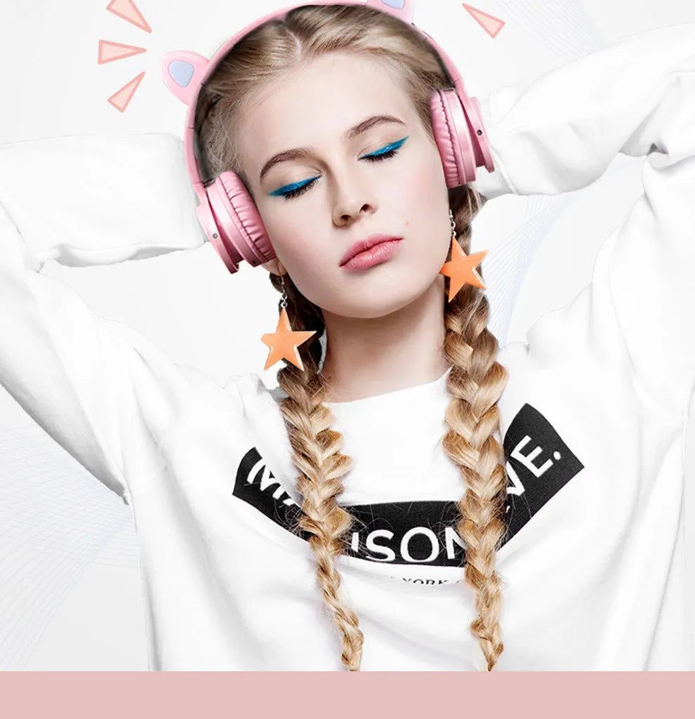 Pink and white Luminous wireless Bluetooth gaming headset with over-ear earcups and a braided cable.