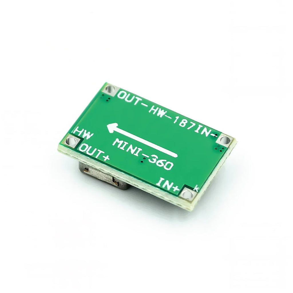 Mini-360 green DC-DC buck converter step down power module on white background