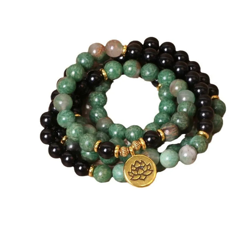 Green and black alloy elastic beaded bracelet showing alternating colours on wrist
