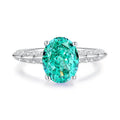 Women's sterling silver ring with a central emerald stone and diamond accent on a geometric band.