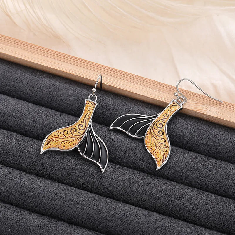 White gold colour alloy fishtail earrings with whale motif retro design