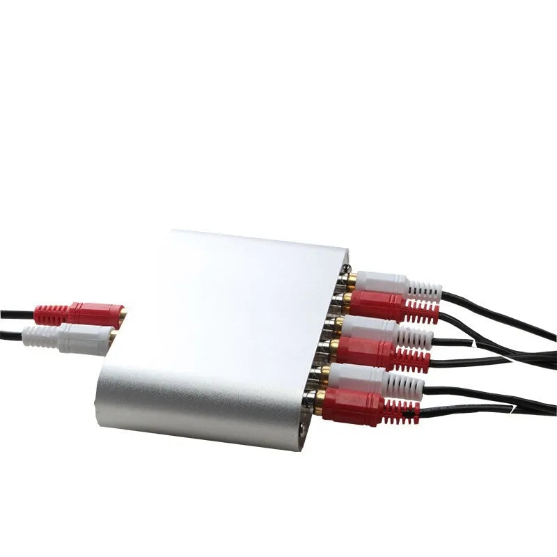 Silver aluminium audio source switch unit with front-panel buttons and infrared remote control.