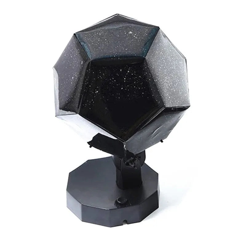 A white plastic LED star projector night light with remote control on a table.