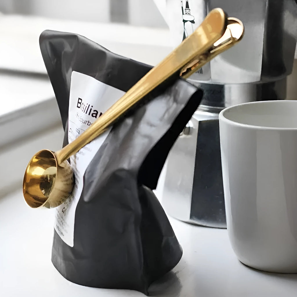 Silver stainless steel coffee clip spoon measuring 17.5cm with belt clip on a coffee bag