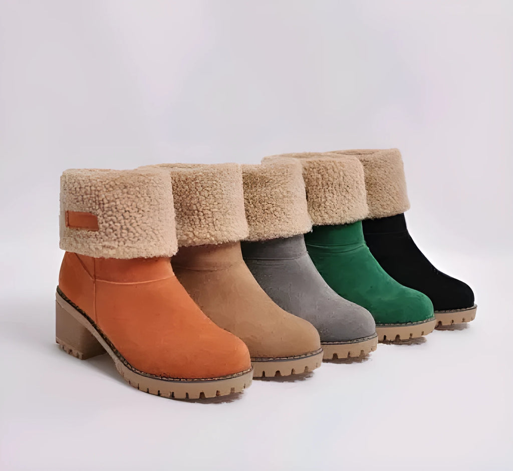 Women's black suede mid-tube snow boots with a thick heel and round toe on a waterproof platform sole.