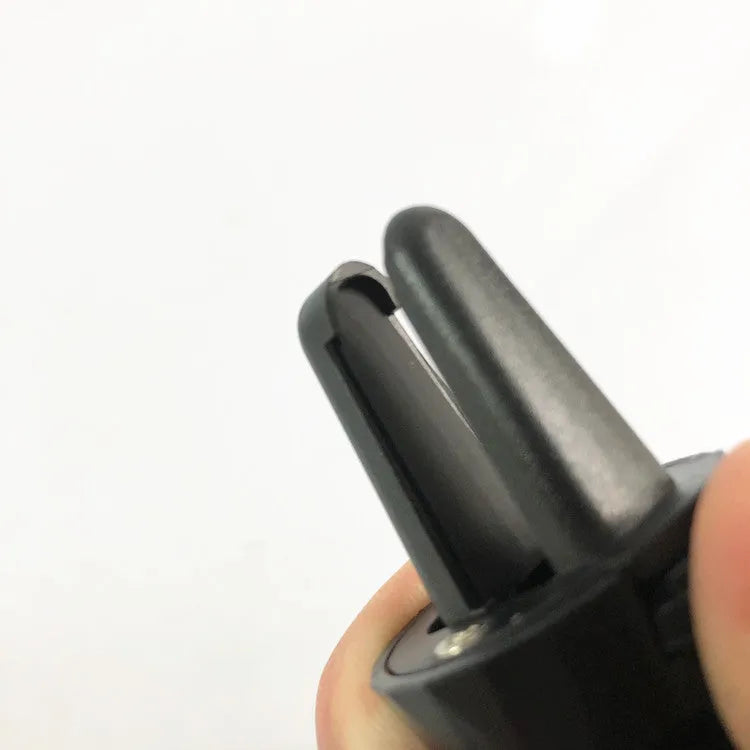 Black car phone holder mounted on car air vent with adjustable clamp mechanism